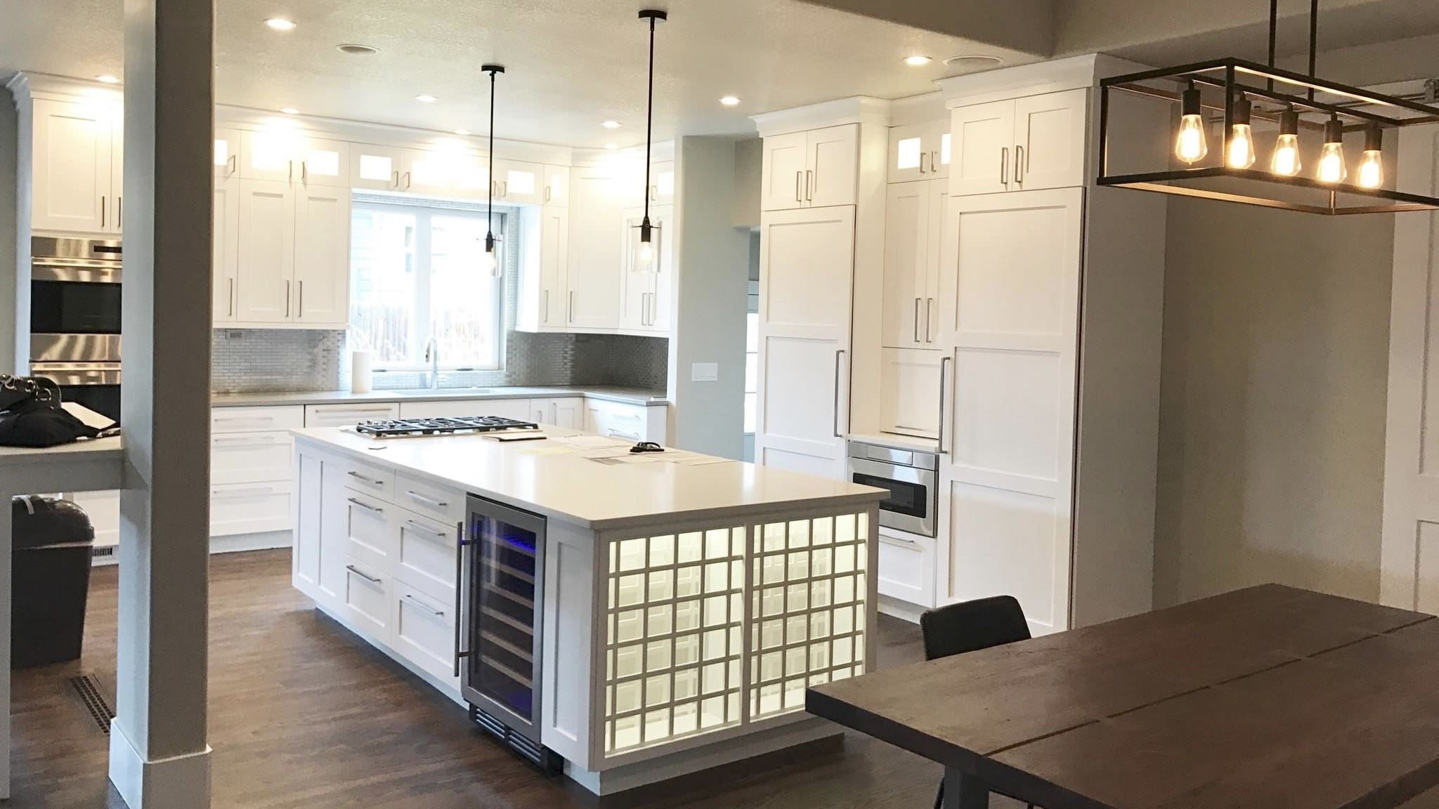 Modern kitchen with white cabinets and island.