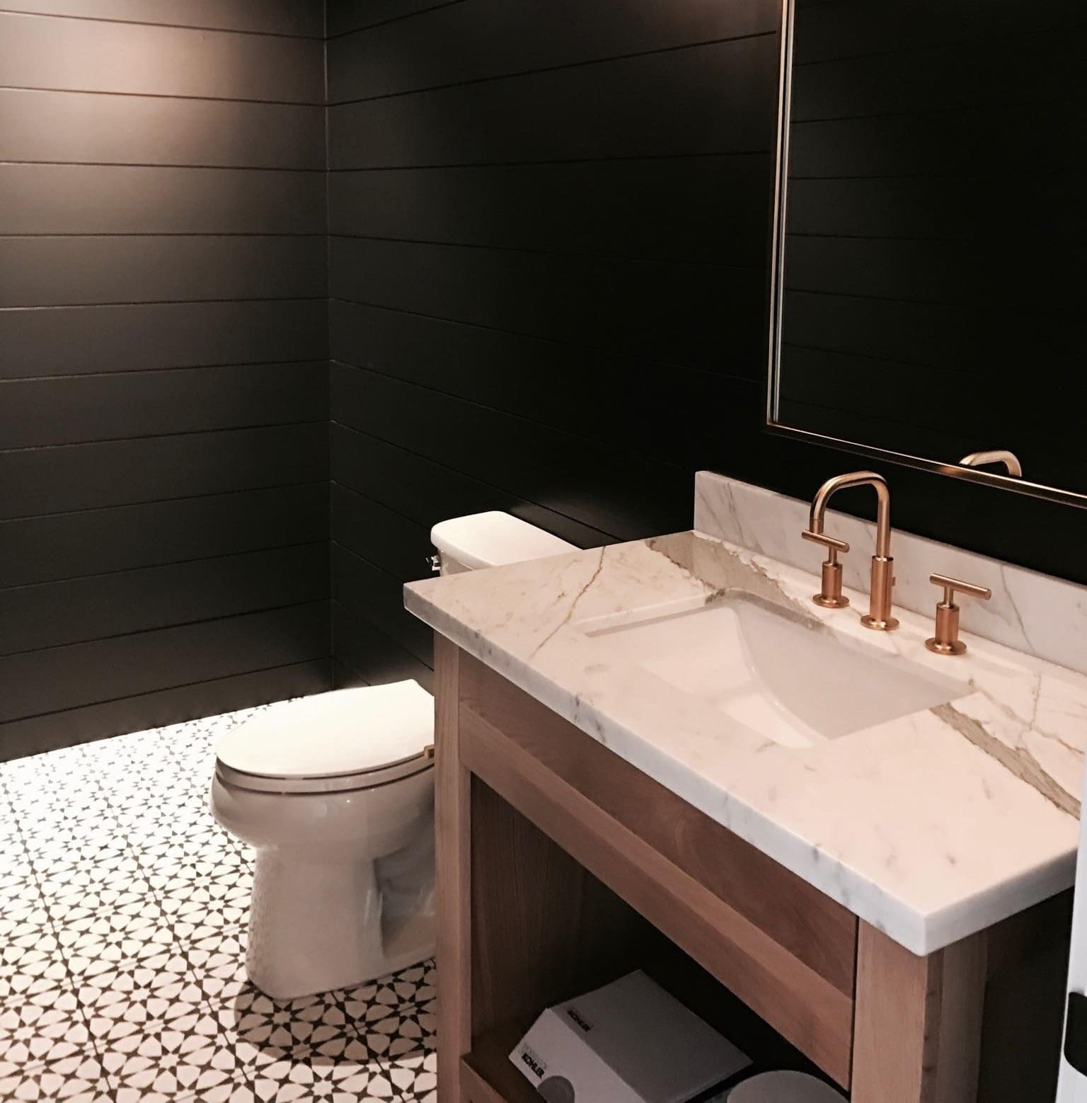 Modern bathroom with marble sink and toilet.