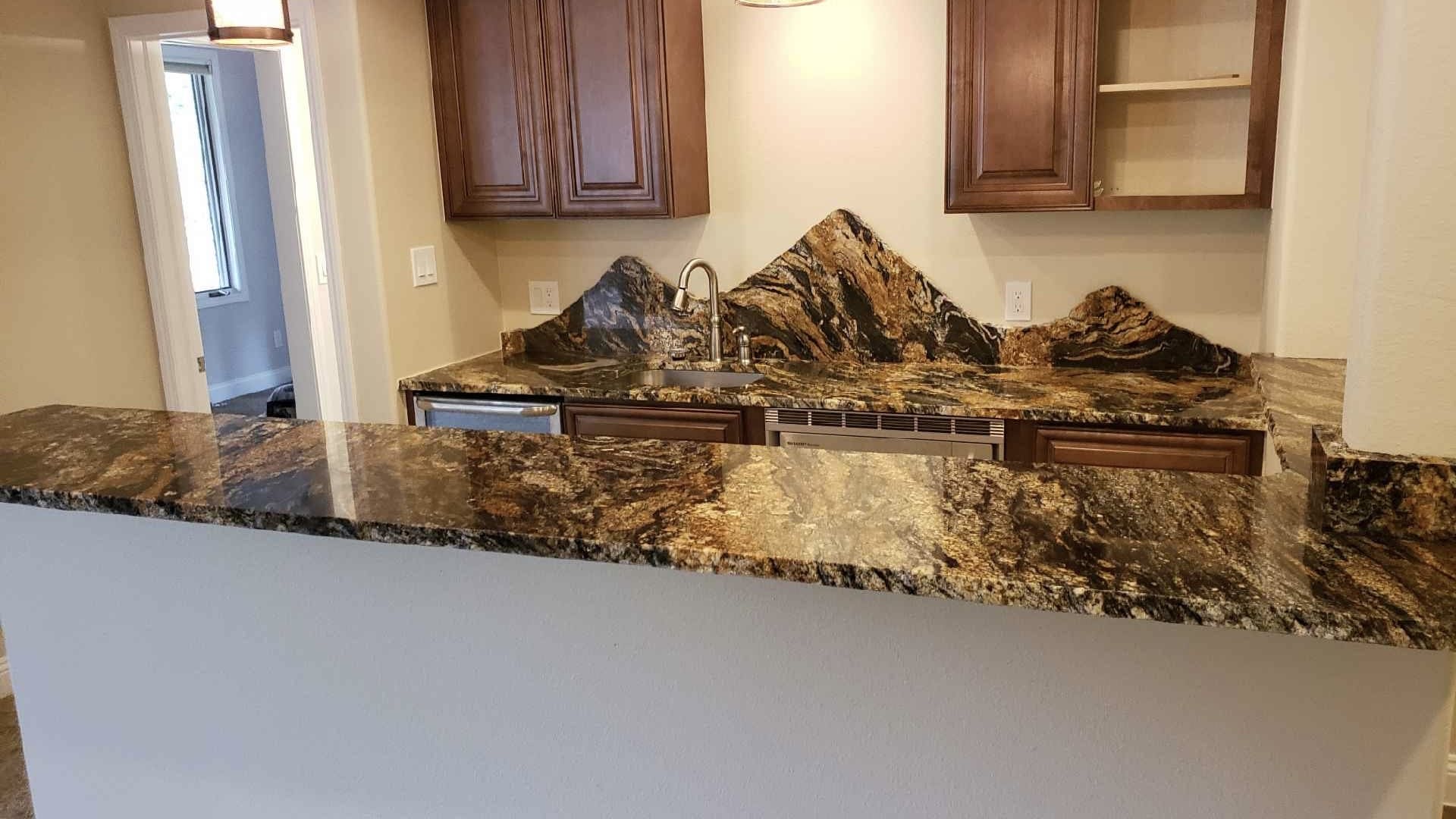 Granite kitchen countertop with wooden cabinets.