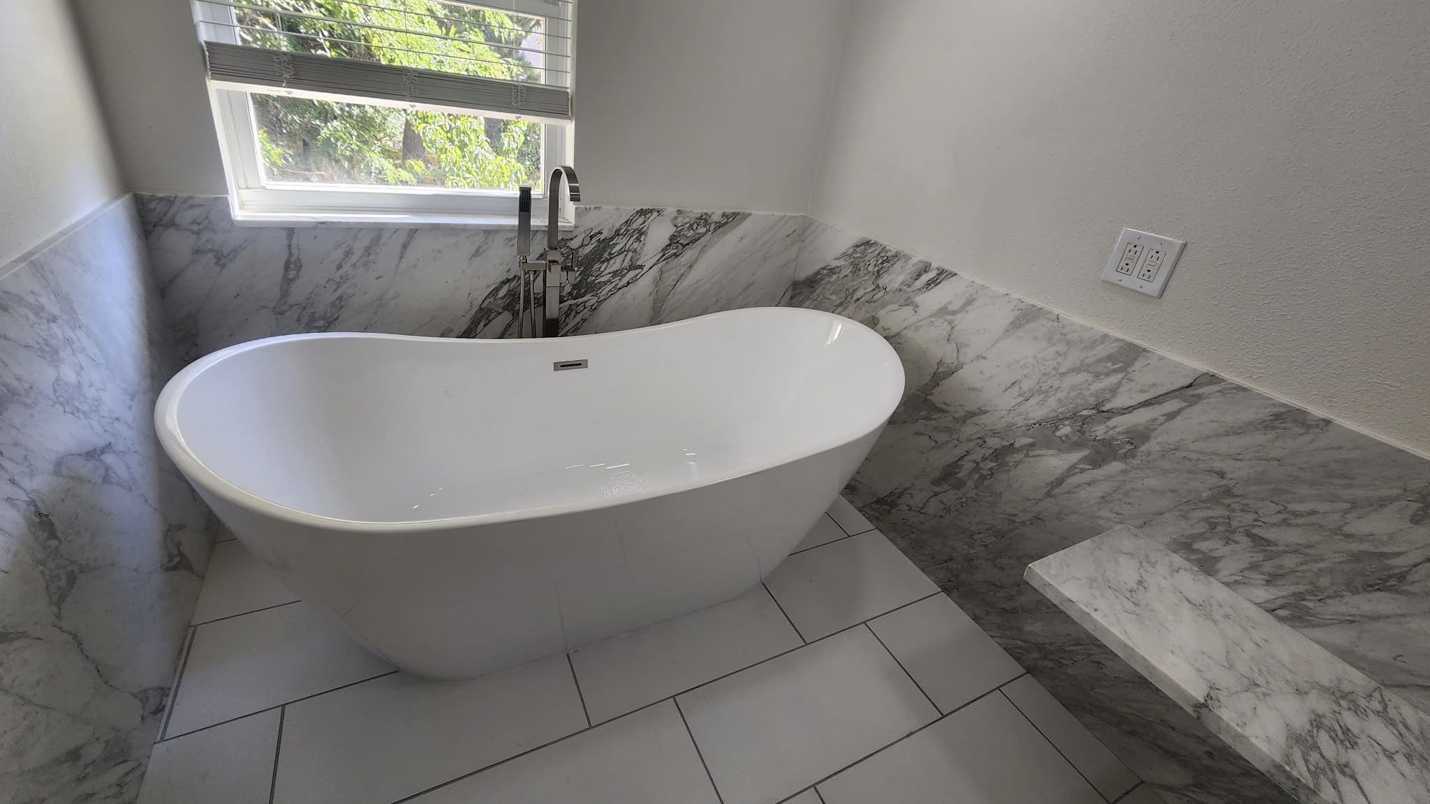 Modern bathroom with freestanding bathtub.