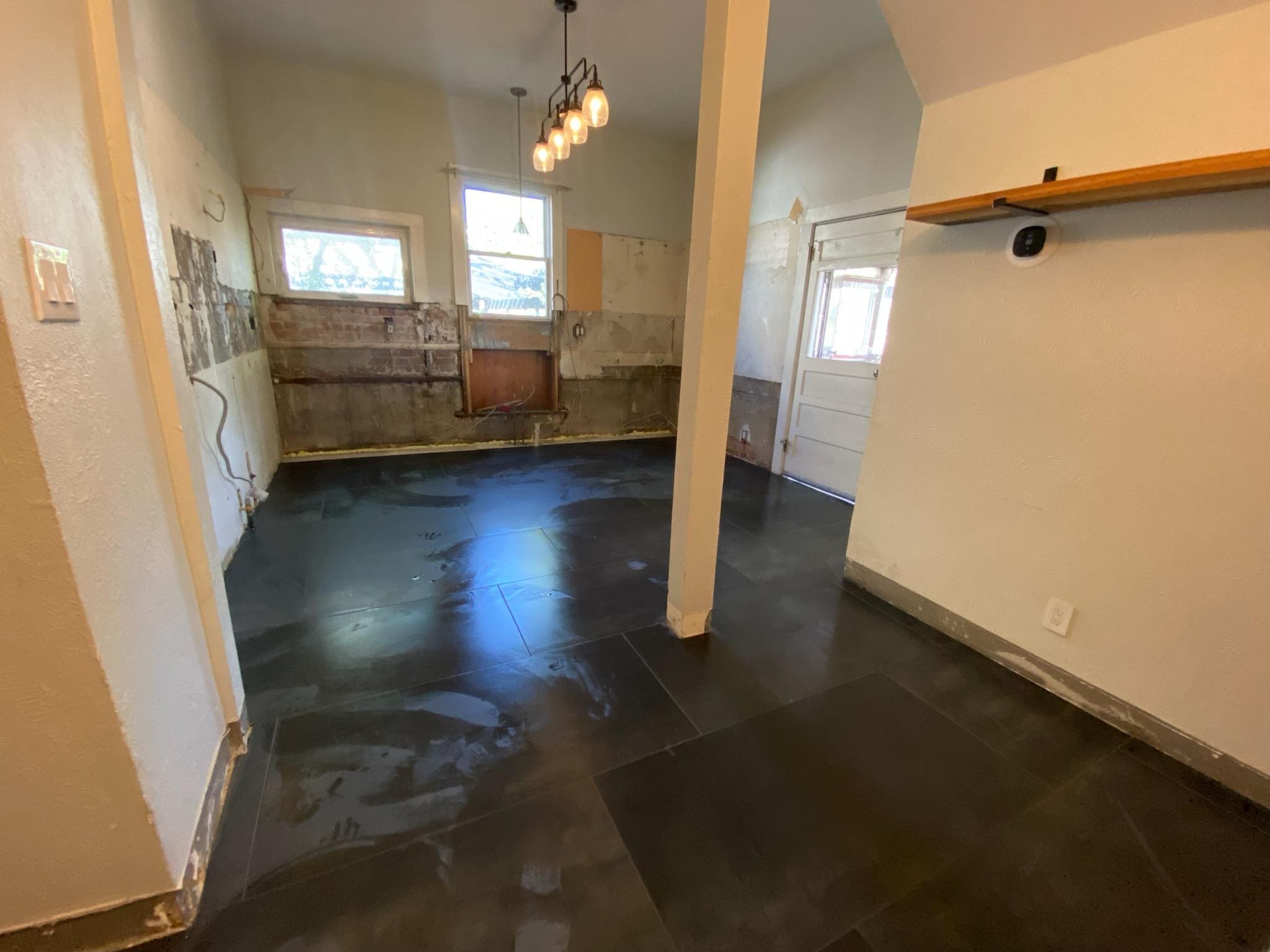 Empty room with dark tiled floor.