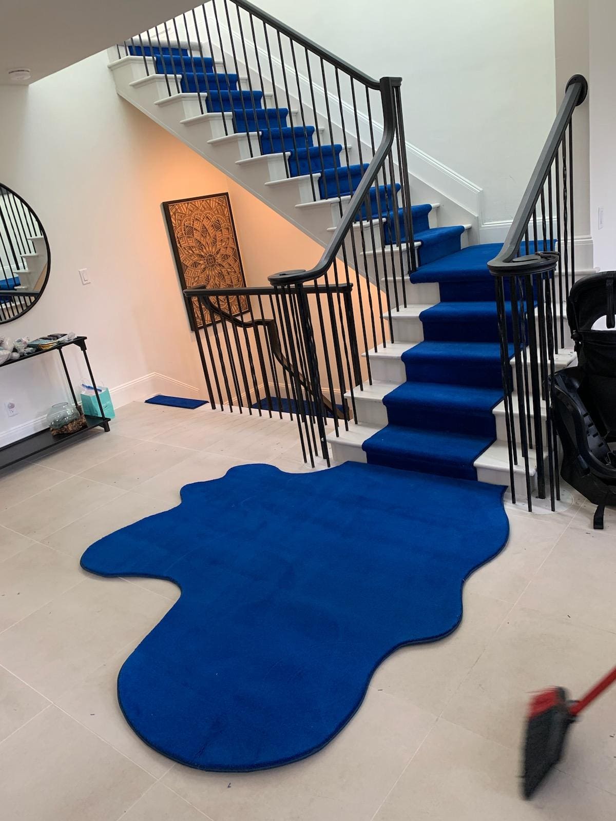 Blue carpeted staircase with unique design.