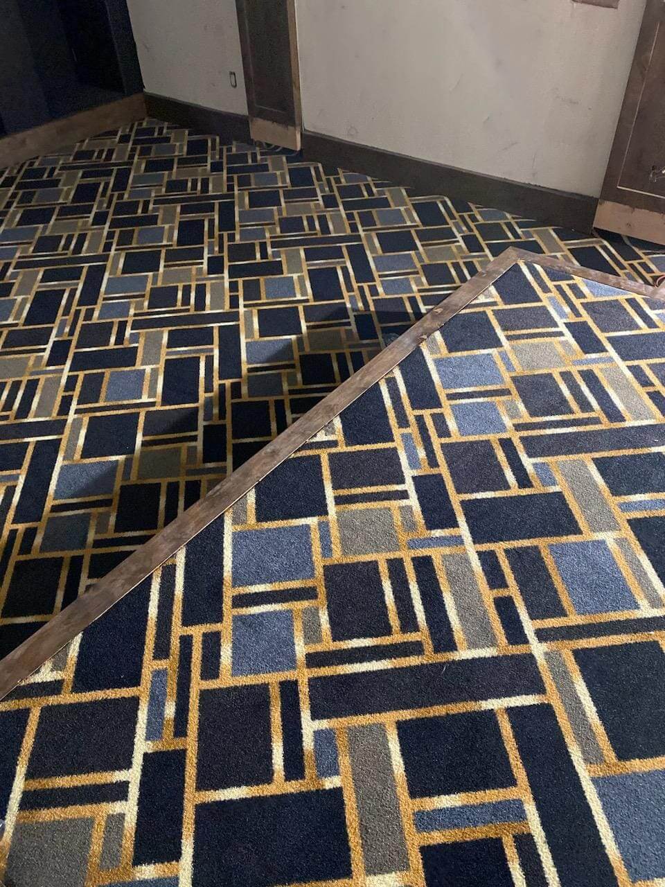 Geometric patterned carpet with contrasting colors.