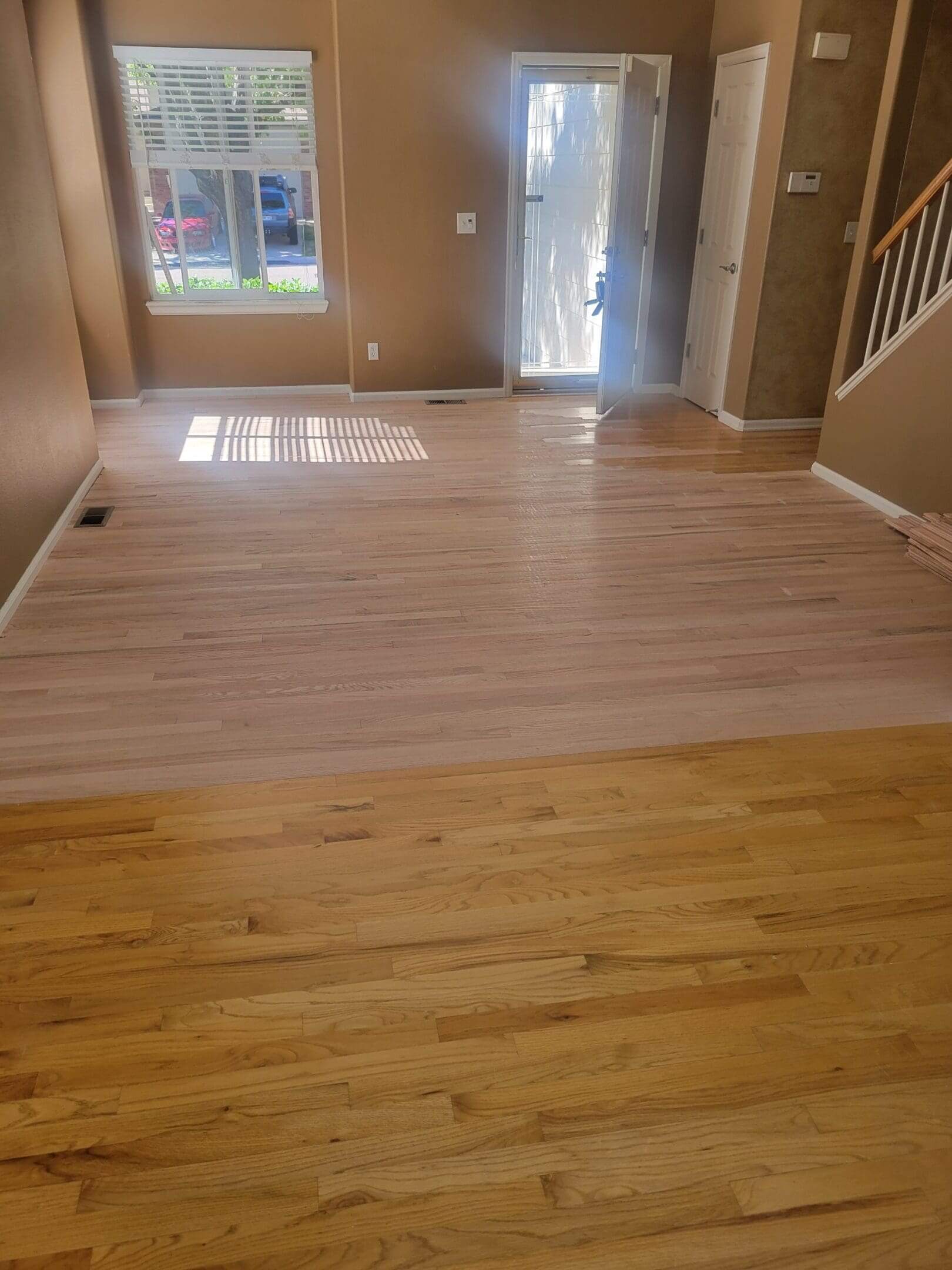 Room with wooden floors and open door.