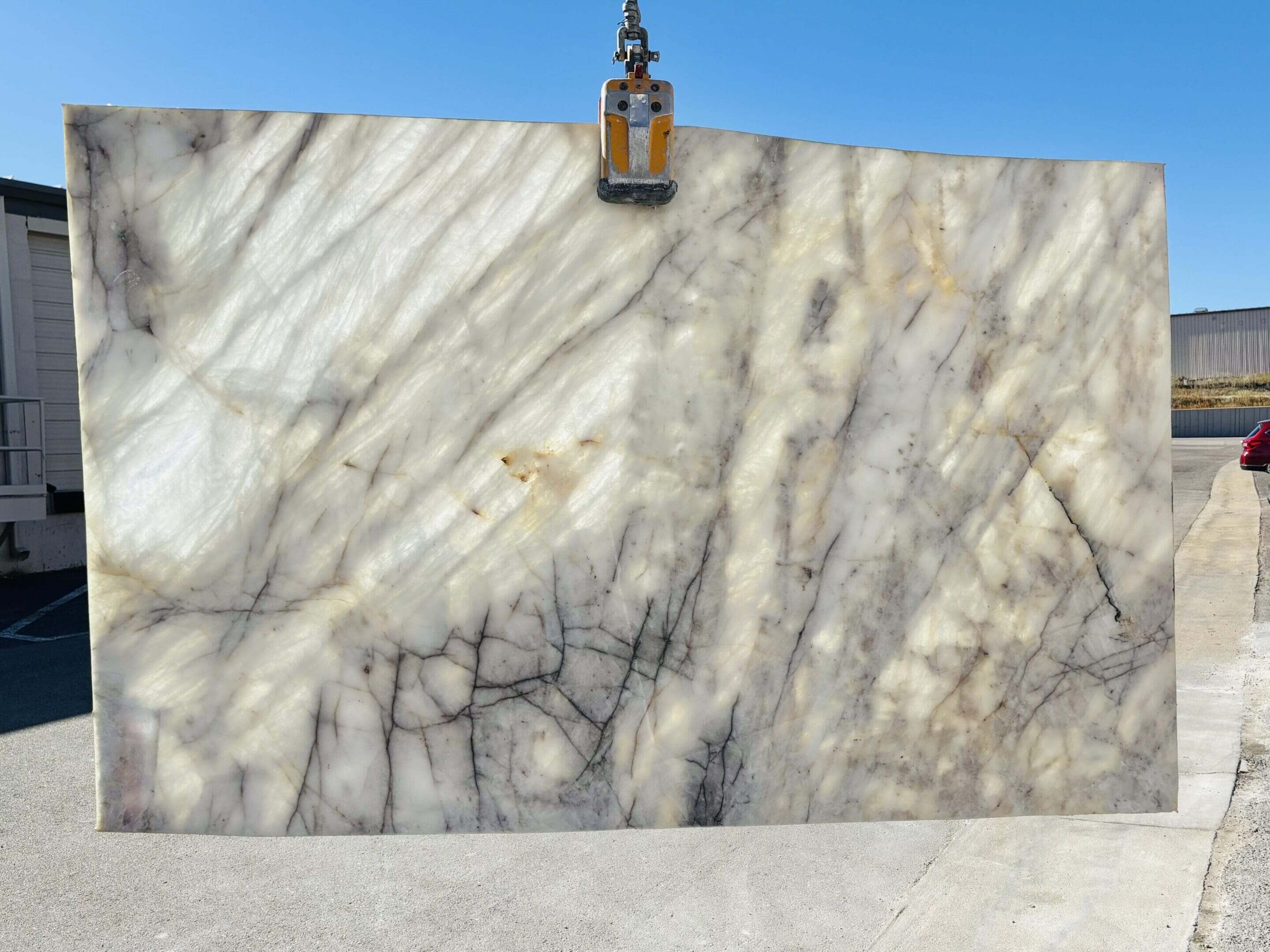 Marble slab displayed under clear blue sky.