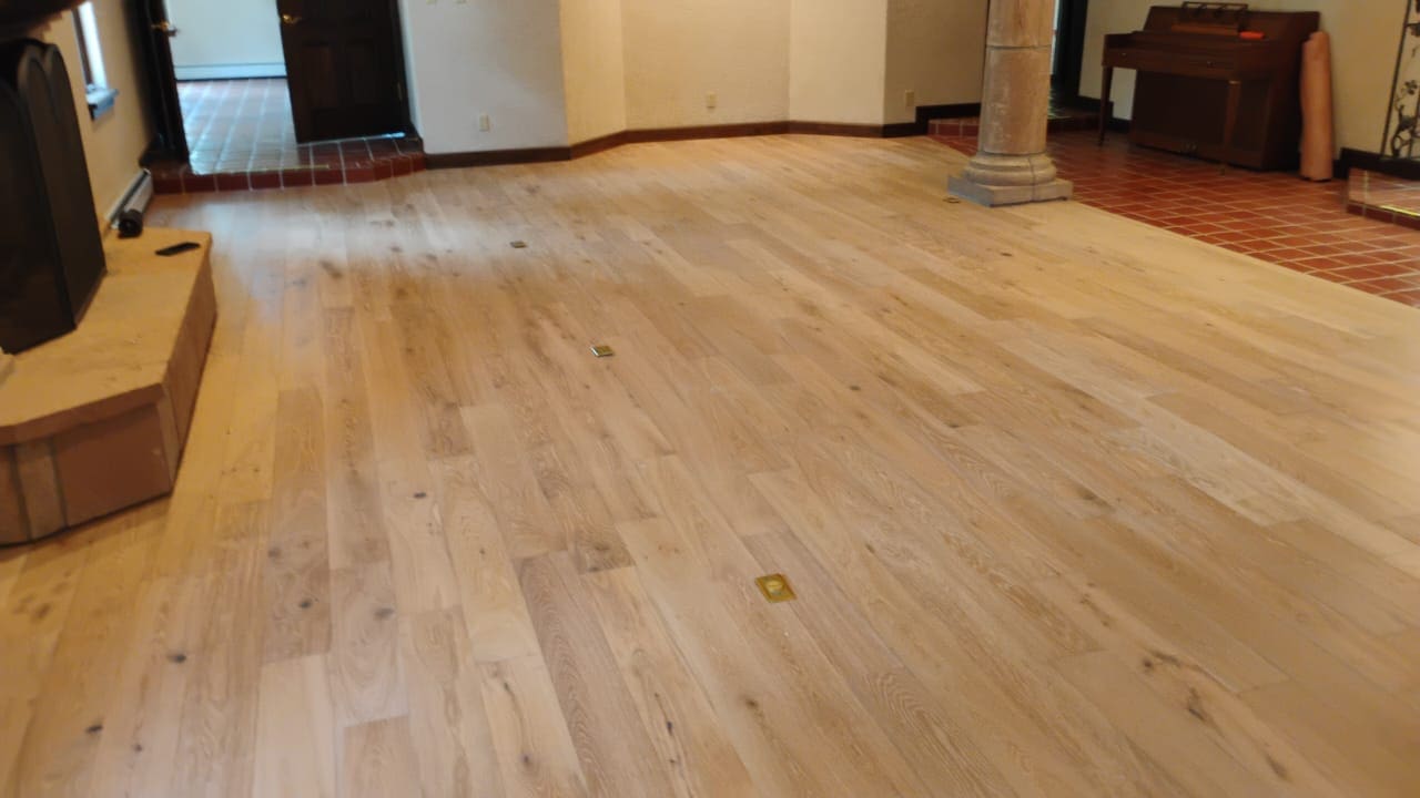 Spacious room with light wood flooring.