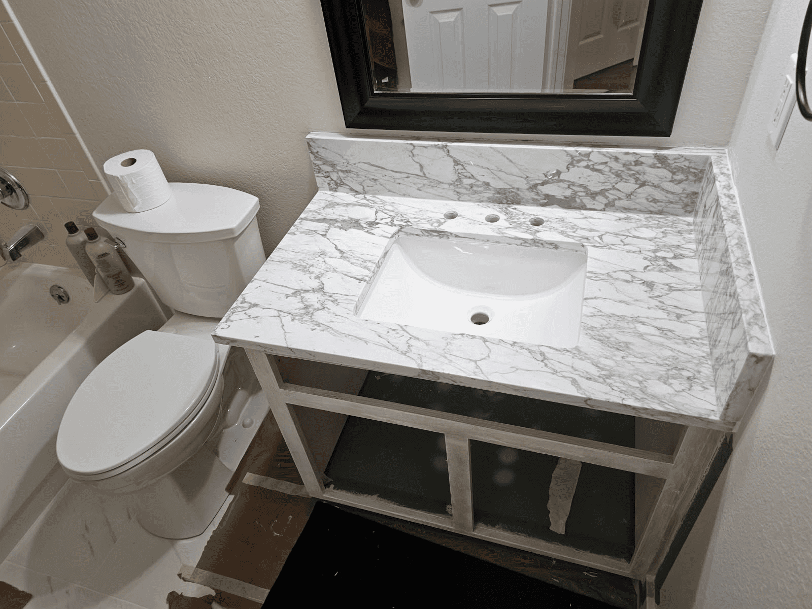 Bathroom with marble sink and toilet.