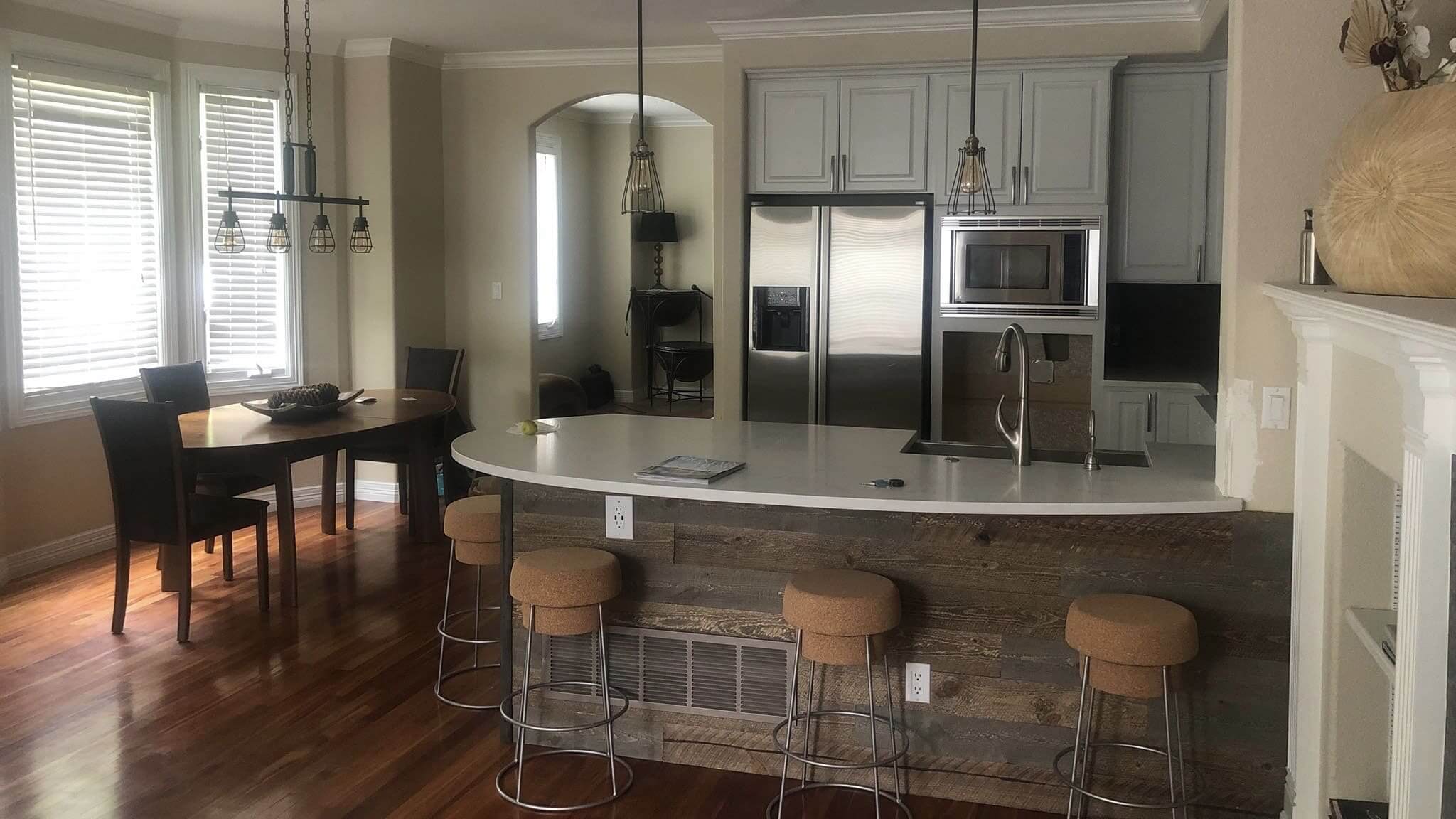 Modern kitchen with island and dining area.