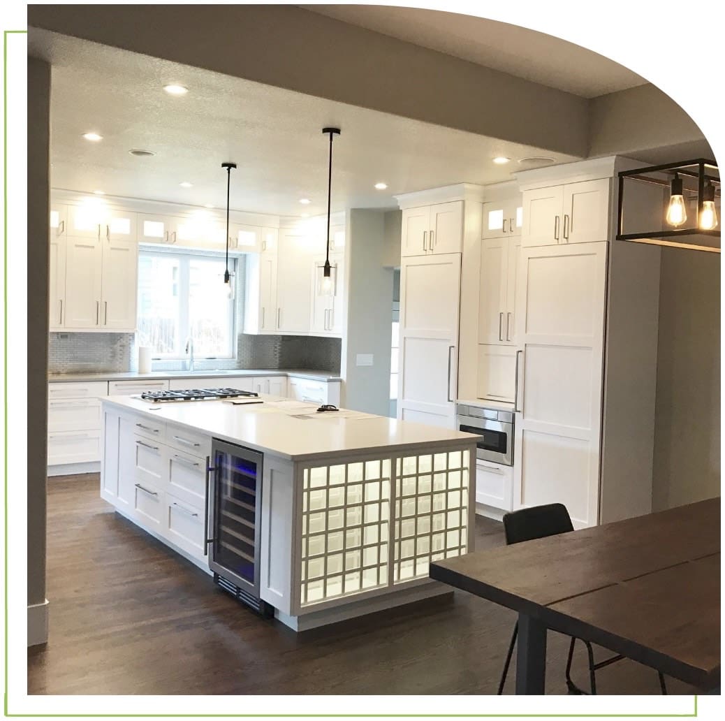 Modern kitchen with large island and lighting.