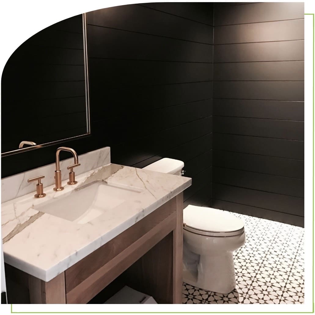 Modern bathroom with dark walls and sink.