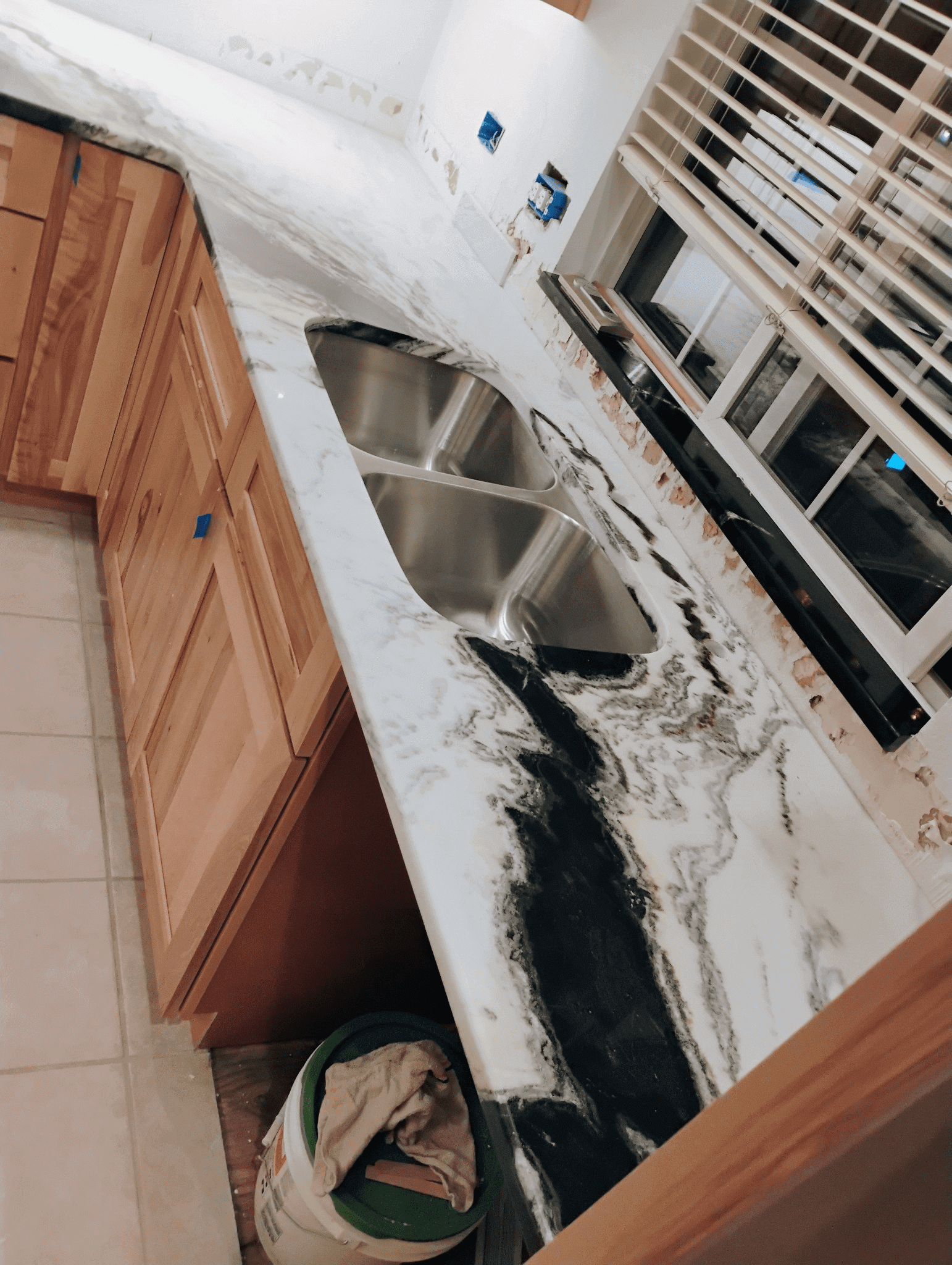 Marble countertop with double sink in kitchen.