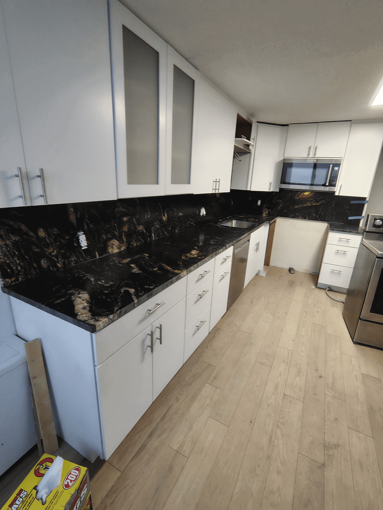 Modern kitchen with black marble countertops.