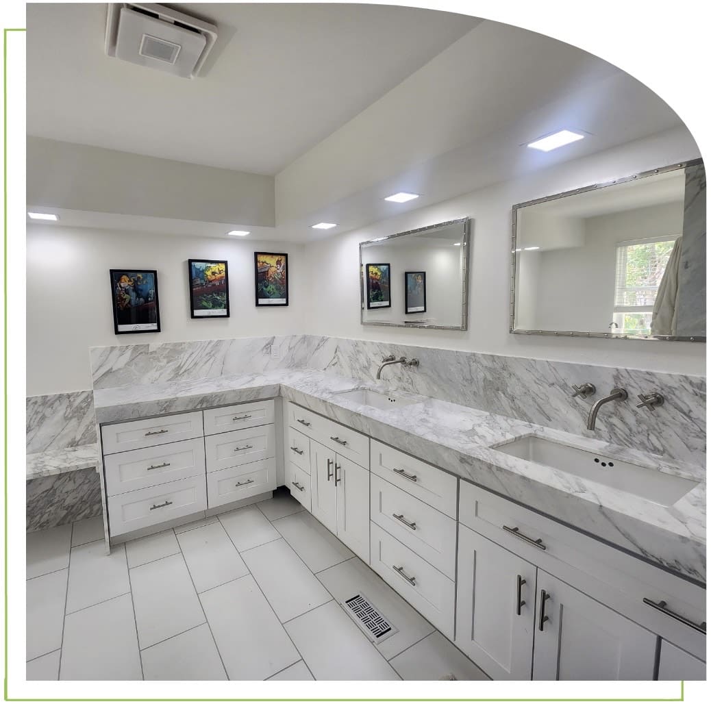 Modern bathroom with marble countertops and artwork.